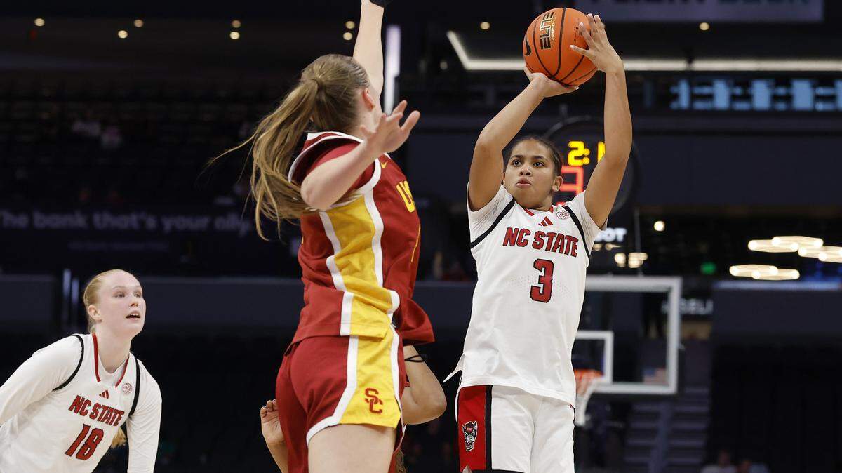 N.C. State’s Zamareya Jones shoots over Southern California’s Gerda Raulusaityte during the second half of the Wolfpack’s 69-68 loss in the Ally Tipoff game on Sunday, Nov. 9, 2025, at Spectrum Center in Charlotte, N.C.