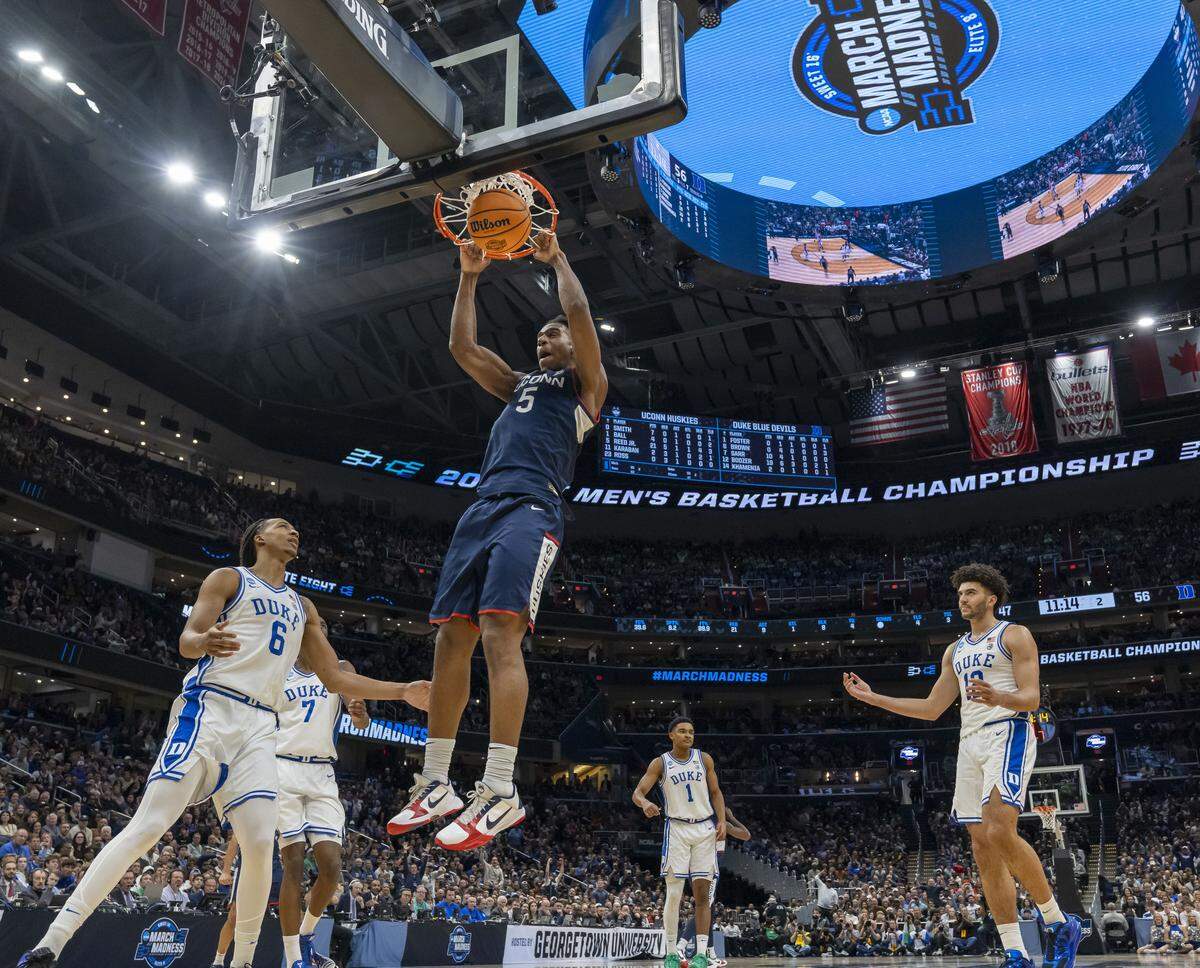 Connecticut forward Tarris Reed Jr. (5) cuts the Duke lead to seven points with a dunk in the second half on Sunday, March 29, 2026, in the NCAA East Regional Championship, at Capital One Arena in Washington, D.C.