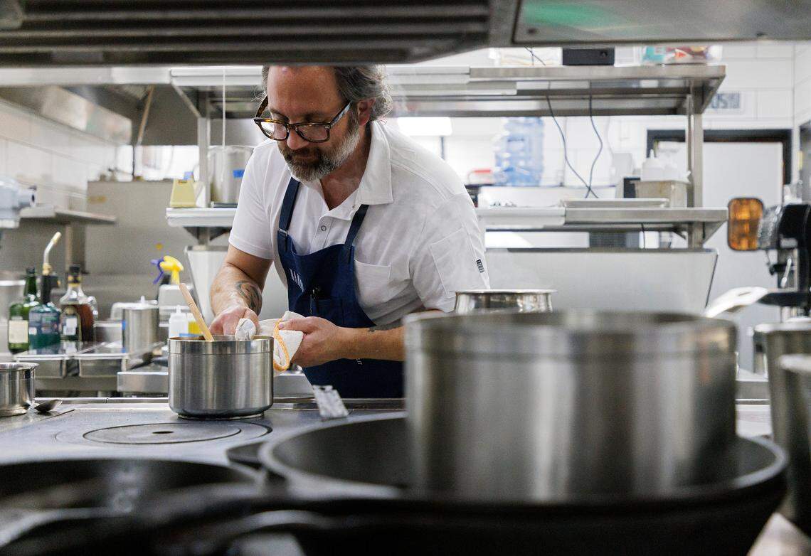 Nate Garyantes, co-chef and co-owner of Nanas, prepares a dish in the restaurant’s kitchen on Wednesday, Nov. 22, 2023, in Durham, N.C.