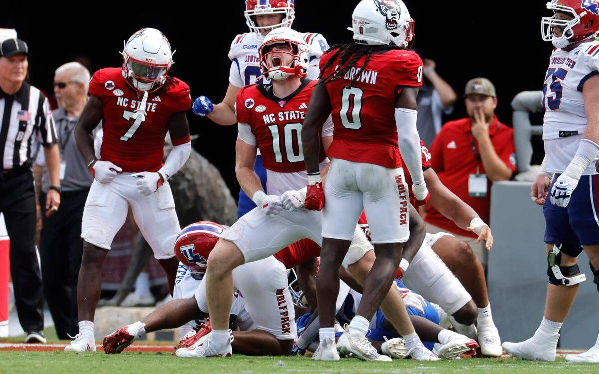 N.C. State linebacker Caden Fordham (10) celebrates stopping Louisiana Tech running back Omiri Wiggins (22) for a loss on second and goal from the one-yard line during the second half of N.C. State’s 30-20 victory over LA Tech at Carter-Finley Stadium in Raleigh, N.C., Saturday, Sept. 14, 2024. LA Tech would have to kick a field goal.