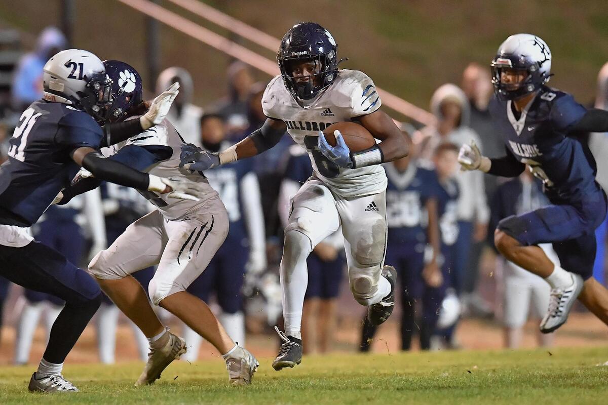 Millbrpook running back Xavier Pugh (6) runs up the middle for the first down against Hillside in the first half. The Hillside Hornets and the Millbrook Wildcats met in the NCHSAA 4a fourth round playoff game in Durham, NC, on November 25, 2022.
