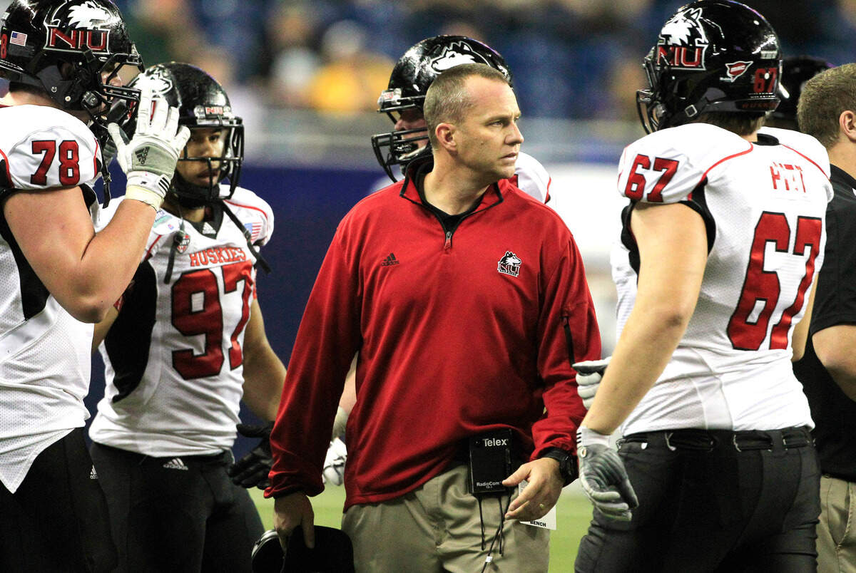 In this 2012 file photo, Northern Illinois head coach Dave Doeren, center, prepares to talk to his team during the Mid-American Conference championship game against Kent State, Nov. 30, 2012.
