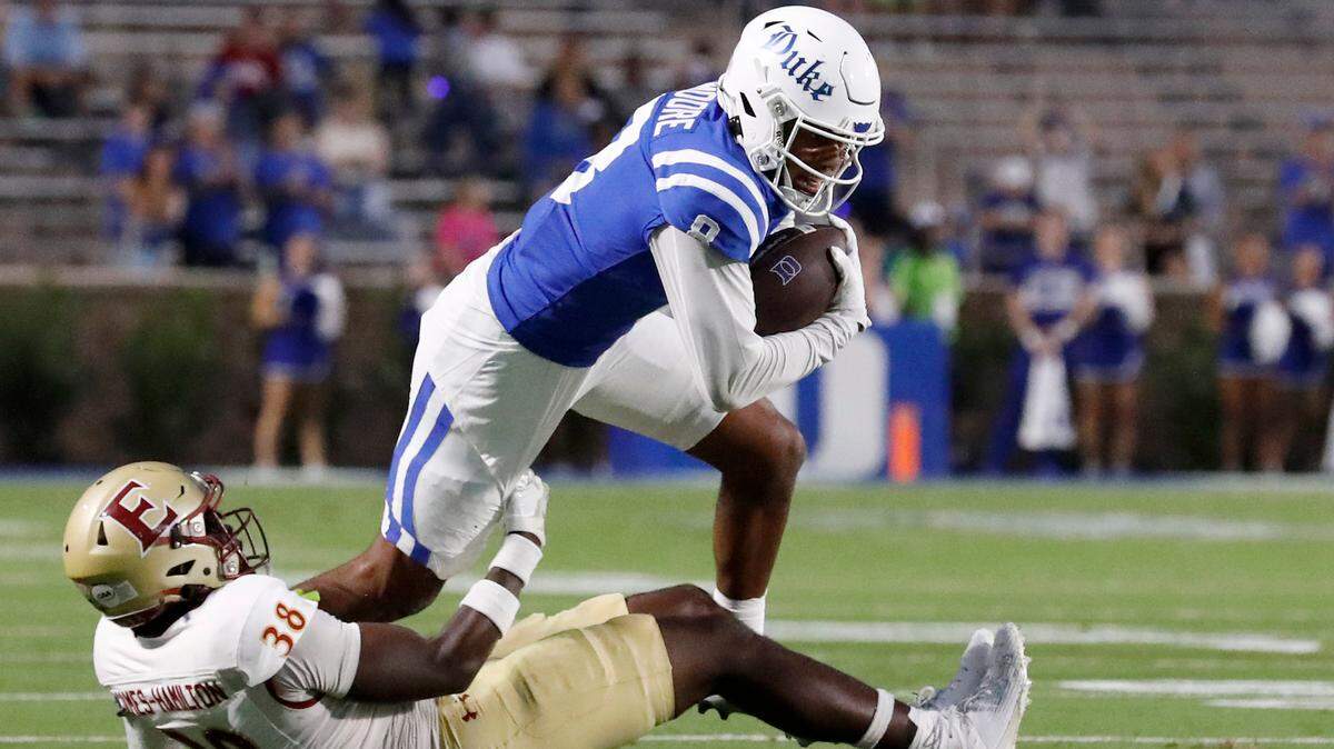 Duke’s Jordan Moore runs the ball past Elon’s DJ Hamilton during the first half of the Blue Devils’ season opener on Friday, Aug. 30, 2024, at Wallace Wade Stadium in Durham, N.C.