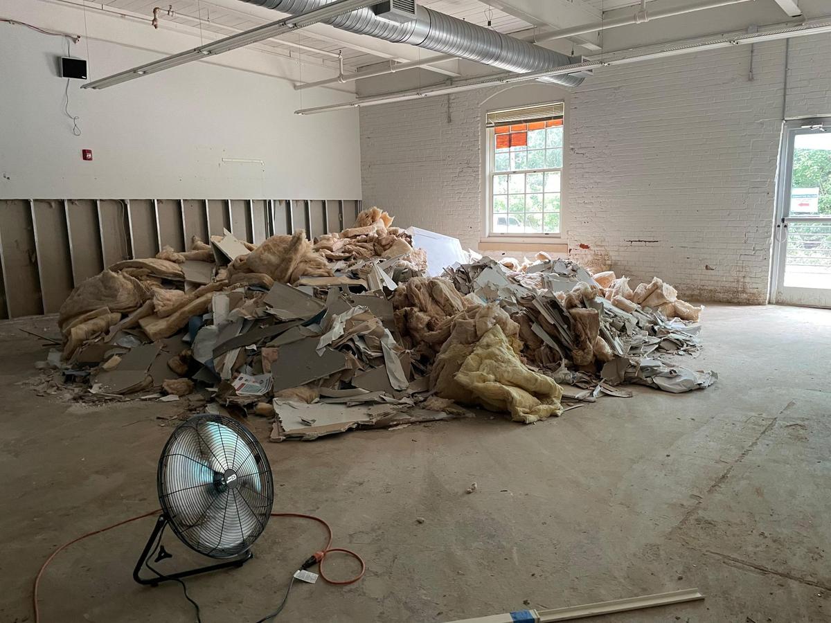 Drywall and insulation were heaped in a corner of The Expedition School before being removed on Thursday, July 17, 2025. The Lower School, which houses K-4 classrooms and the administration, was severely damaged in a July 6 flood.