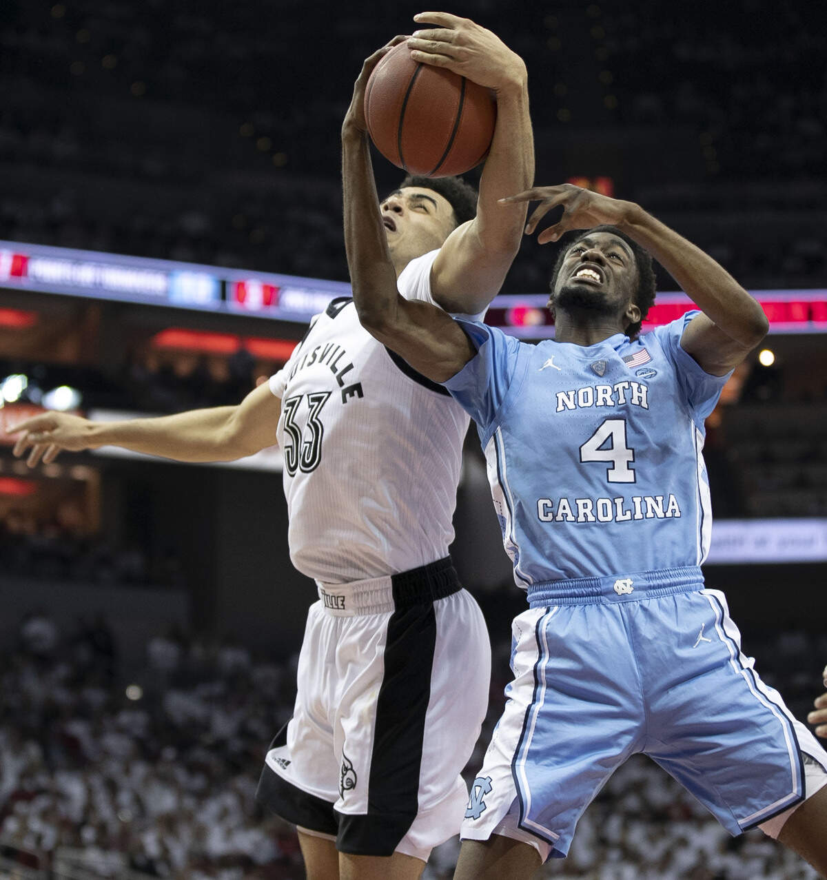 North Carolina’s Brandon Robinson (4) battles for an offensive rebound with Louisville’s Jordan Nwora (33) during the second half on Saturday, February 2, 2019 at the KFC Yum! Center in Louisville, Ky.