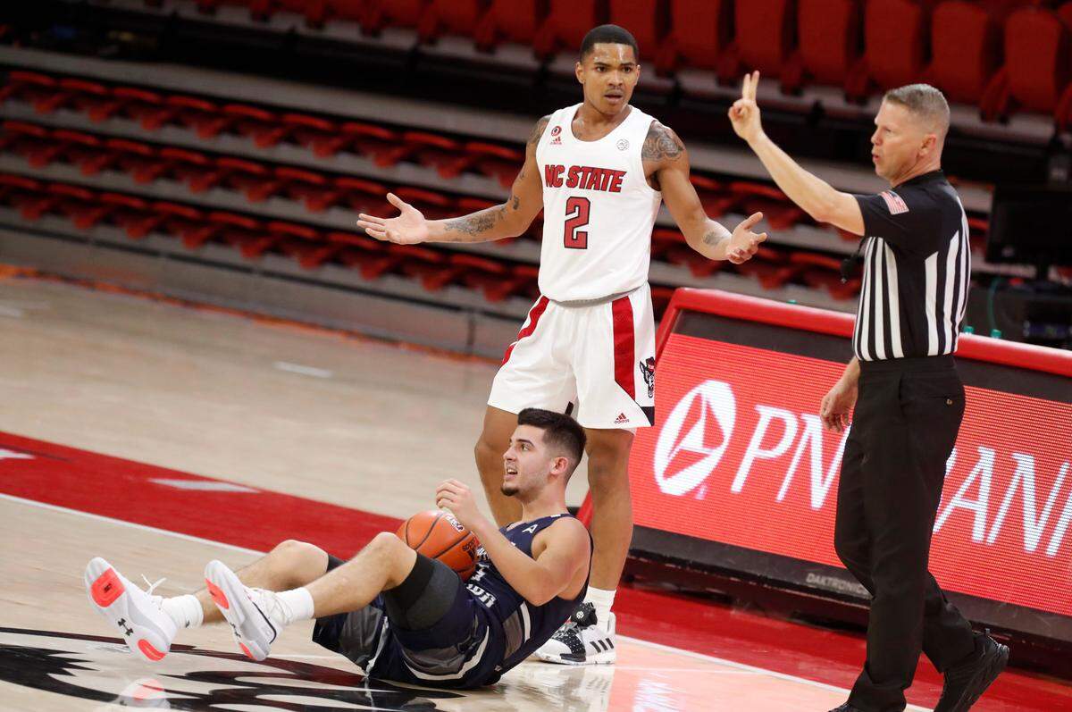 N.C. State’s Shakeel Moore (2) can’t believe he was called for a foul while guarding North Florida’s Jose Placer (15) during the second half of N.C. State’s 86-51 victory over North Florida in the Mako Medical Wolfpack Invitational at Reynolds Coliseum in Raleigh, N.C., Friday, Nov. 27, 2020.