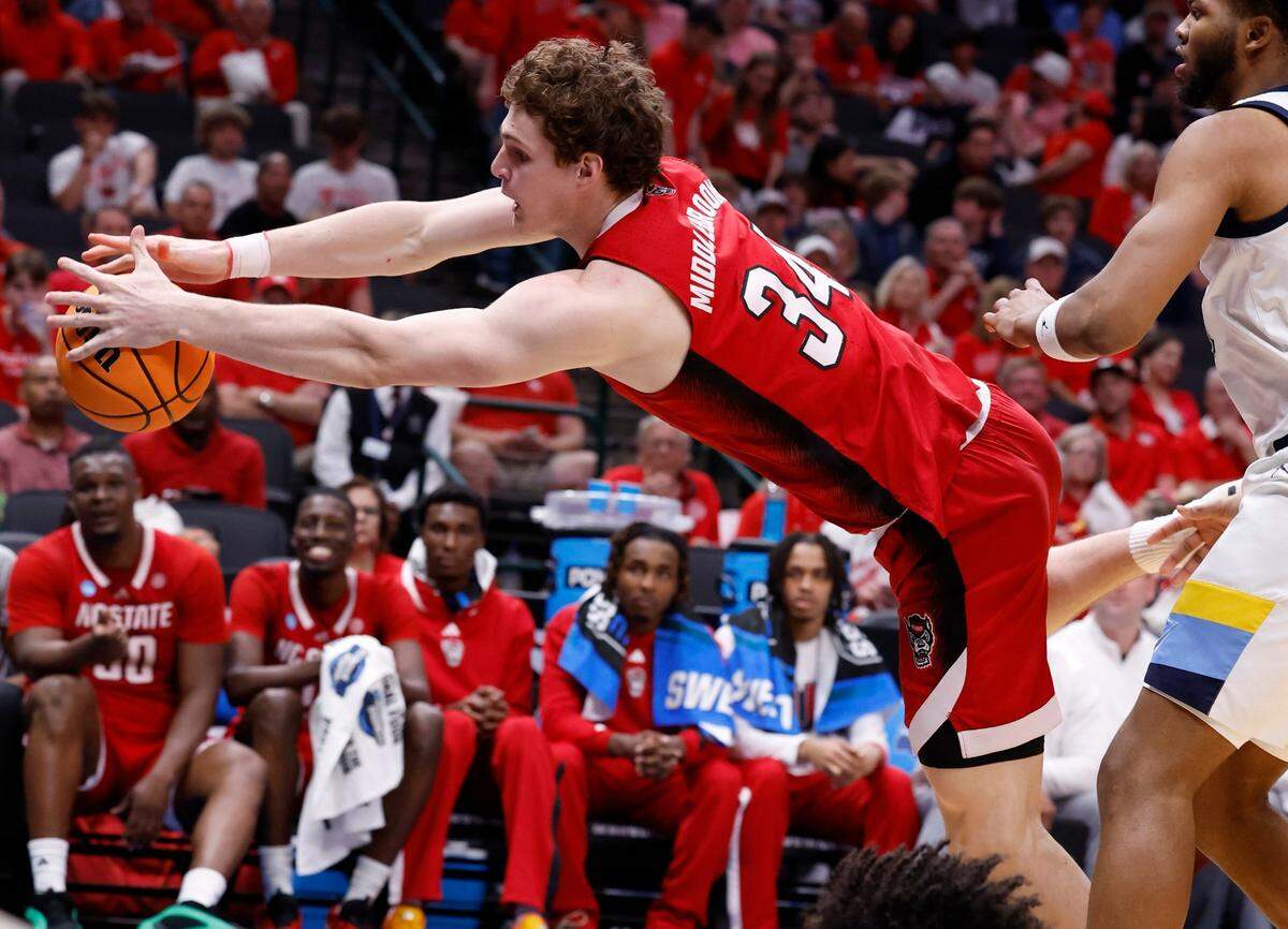 N.C. State’s Ben Middlebrooks (34) tries to save the ball from going out of bounds during the second half of N.C. State’s 67-58 victory over Marquette in their NCAA Tournament Sweet 16 game at the American Airlines Center in Dallas, Texas, Friday, March 29, 2024.