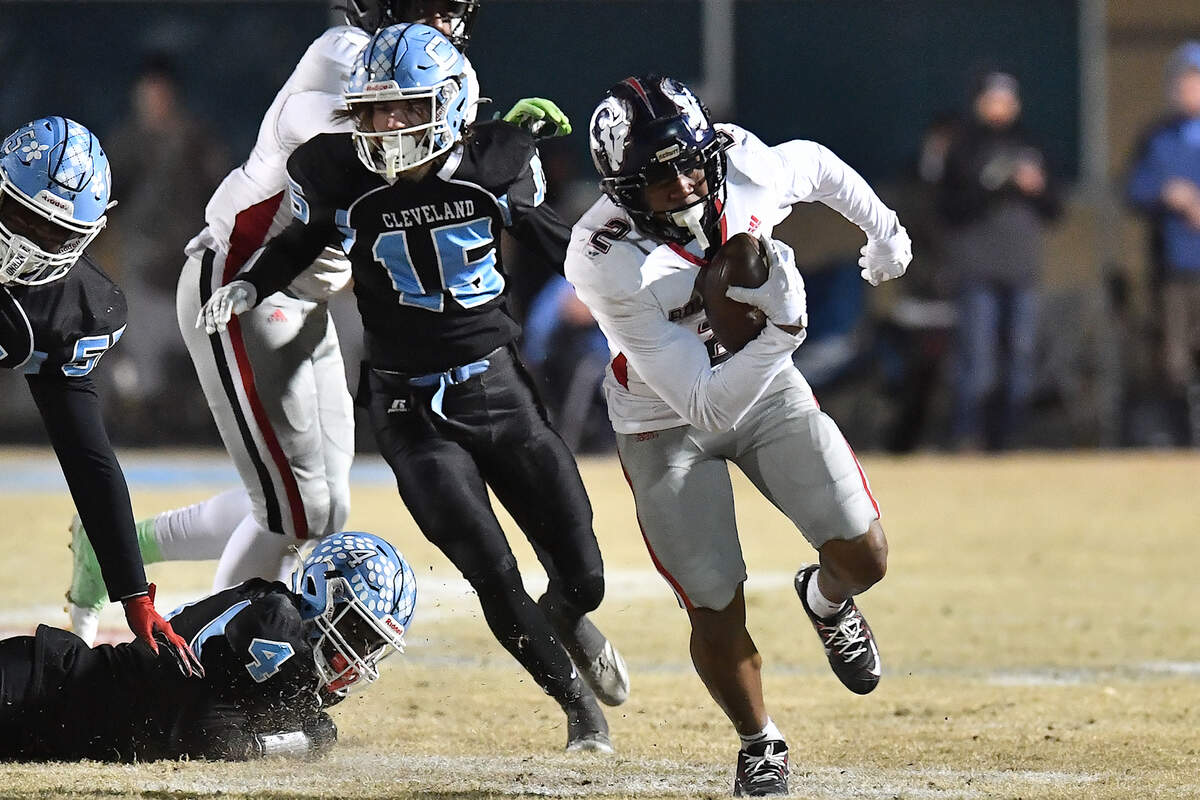 Rolesville running back Amir Brown (2) runs for the first down ahead of Cleveland’s Aiden Stephenson (15) during the second half. The Rolesville Rams and the Cleveland Rams met in the fourth round of the NCHSAA 4A football playoffs in Clayton, N.C. on December 6, 2024.