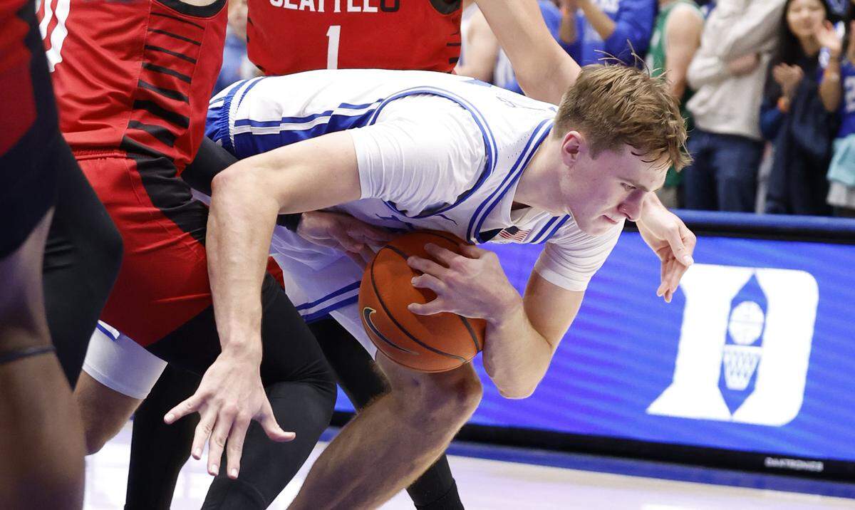 Duke’s Cooper Flagg (2) is fouled as he drives by Seattle’s Brayden Maldonado (0) during the first half of Duke’s game against Seattle at Cameron Indoor Stadium in Durham, N.C., Friday, Nov. 29, 2024.