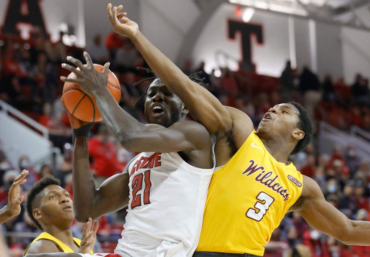 N.C. State’s Ebenezer Dowuona (21) pulls in the rebound from Bethune-Cookman’s Marcus Garrett (3) during the first half of N.C. State’s game against Bethune-Cookman University at Reynolds Coliseum in Raleigh, N.C., Thursday, December 9, 2021.