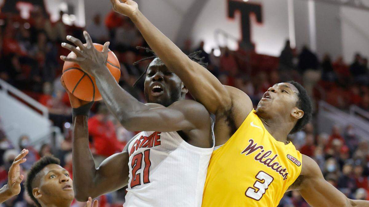 N.C. State’s Ebenezer Dowuona (21) pulls in the rebound from Bethune-Cookman’s Marcus Garrett (3) during the first half of N.C. State’s game against Bethune-Cookman University at Reynolds Coliseum in Raleigh, N.C., Thursday, December 9, 2021.