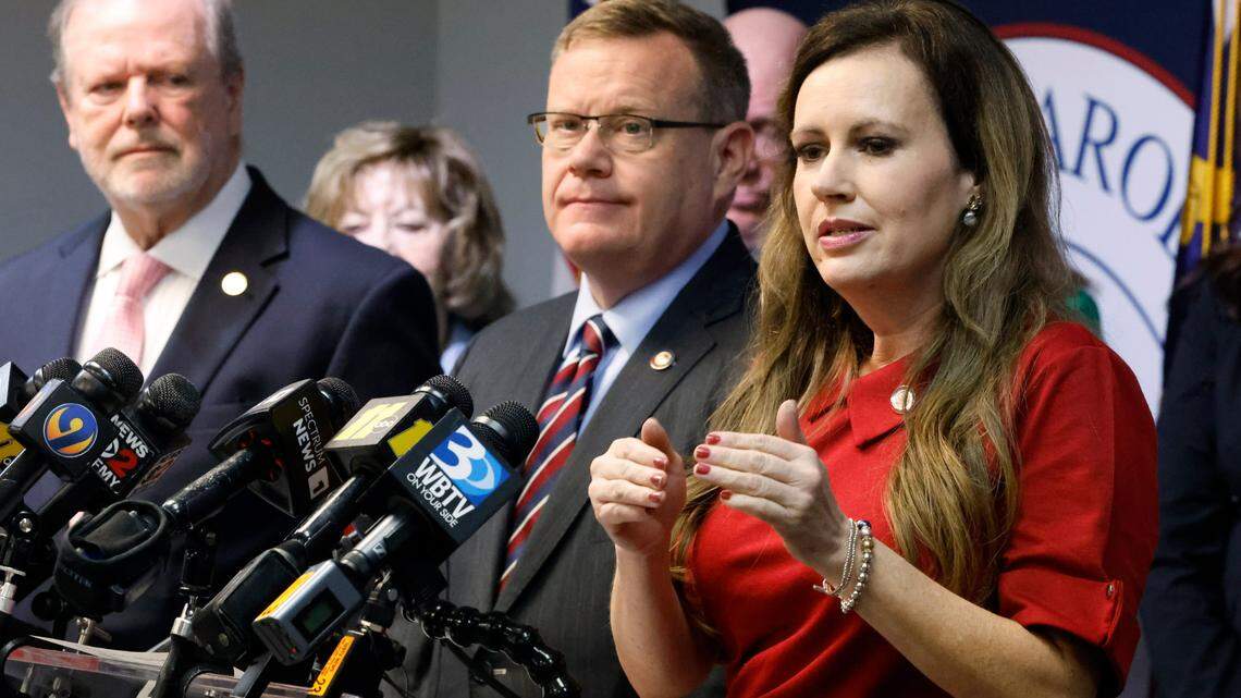 N.C. Senate leader Phil Berger, left, and House Speaker Tim Moore, center, look on as N.C. Rep. Tricia Cotham speaks during a press conference at the N.C. GOP headquarters in Raleigh, N.C. Wednesday, April 5, 2023. The press conference was to announce Rep. Cotham is switching parties to become a member of the House Republican caucus.