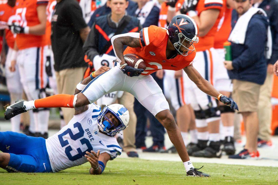 Virginia Cavaliers wide receiver Ra’Shaun Henry (2) is brought down by Duke Blue Devils safety Lummie Young IV (23) during the first quarter of an NCAA football game at Scott Stadium on Saturday October 16, 2021 in Charlottesville, Va. (AP Photo/Mike Caudill)