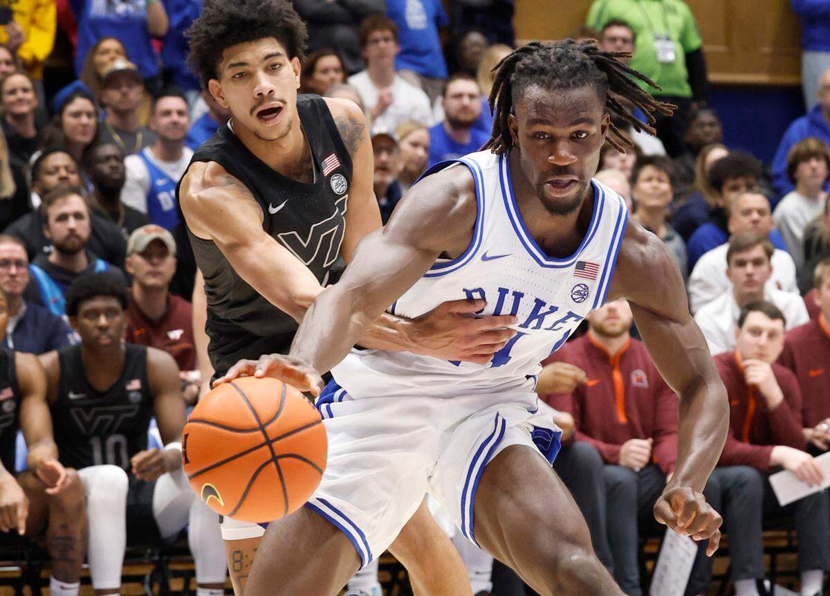 Duke’s Sion James (14) drives around Virginia Tech’s Rodney Brown Jr. (4) during the first half of Duke’s game against Virginia Tech at Cameron Indoor Stadium in Durham, N.C., Tuesday, Dec. 31, 2024.