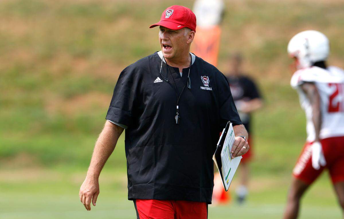 N.C. State head coach Dave Doeren yells to his team during the Wolfpack’s first fall practice in Raleigh, N.C., Wednesday, August 2, 2023.