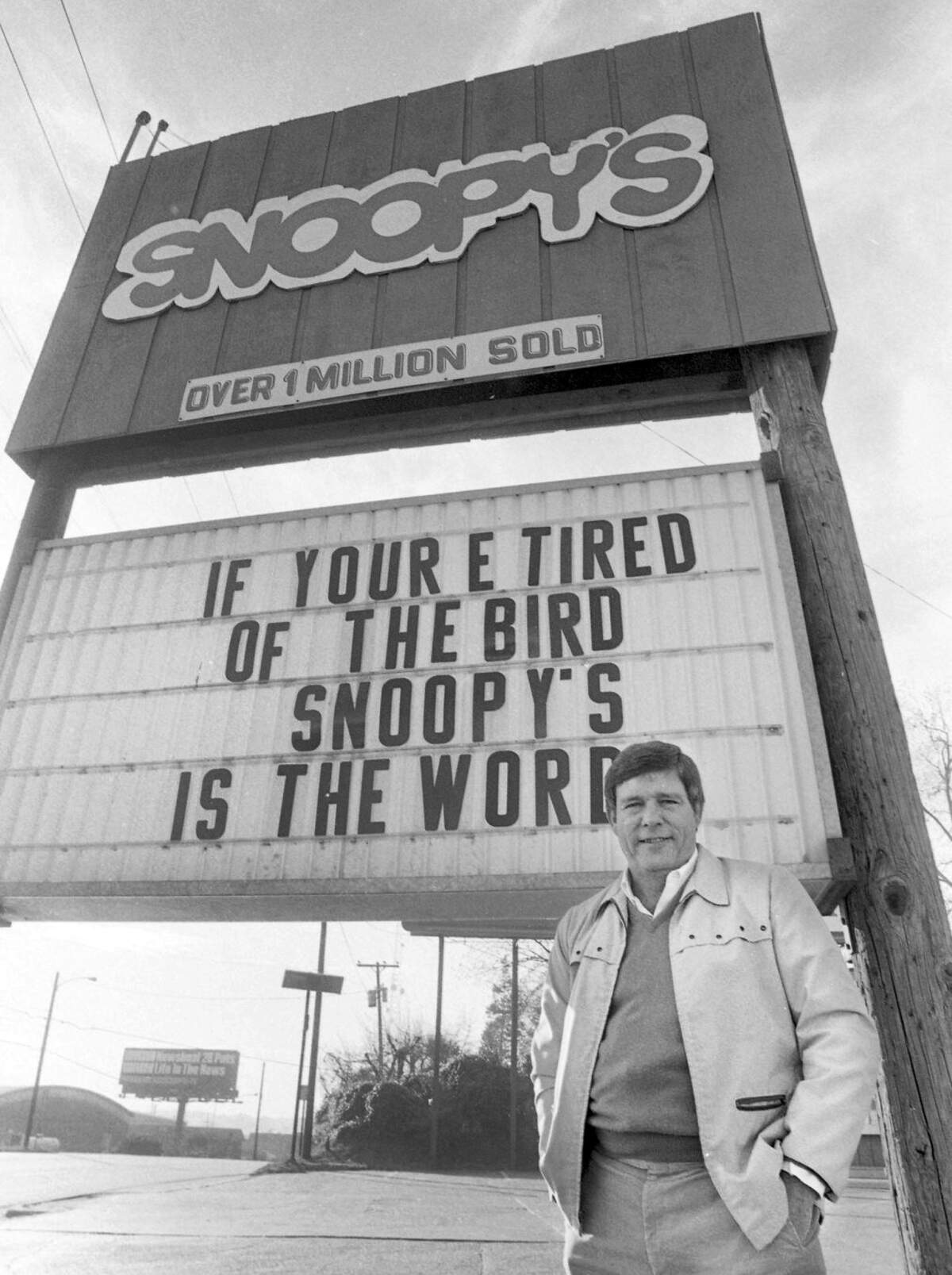 Snoopy’s Hot Dogs owner, Steve Webb, is seen in front of his famous sign on Wake Forest Road that has become known for its quippy one-liners, December 16, 1986.