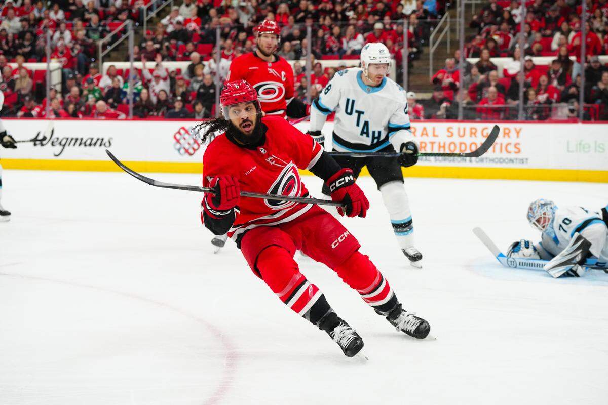 Carolina Hurricanes defenseman Jalen Chatfield (5) celebrates his goal against the Utah Hockey Club during the first period at Lenovo Center. 
