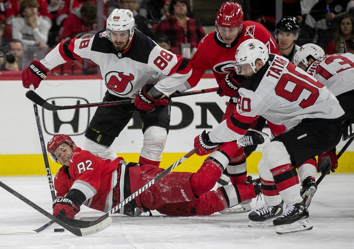 The Carolina Hurricanes Jesperi Kotkaniemi (82) hits the ice as he battles for the puck under New Jersey Devils Tomas Tatar (90) in the first period during Game 1 of their second round Stanley Cup playoff series on Wednesday, May 3, 2023 at PNC Arena in Raleigh, N.C.
