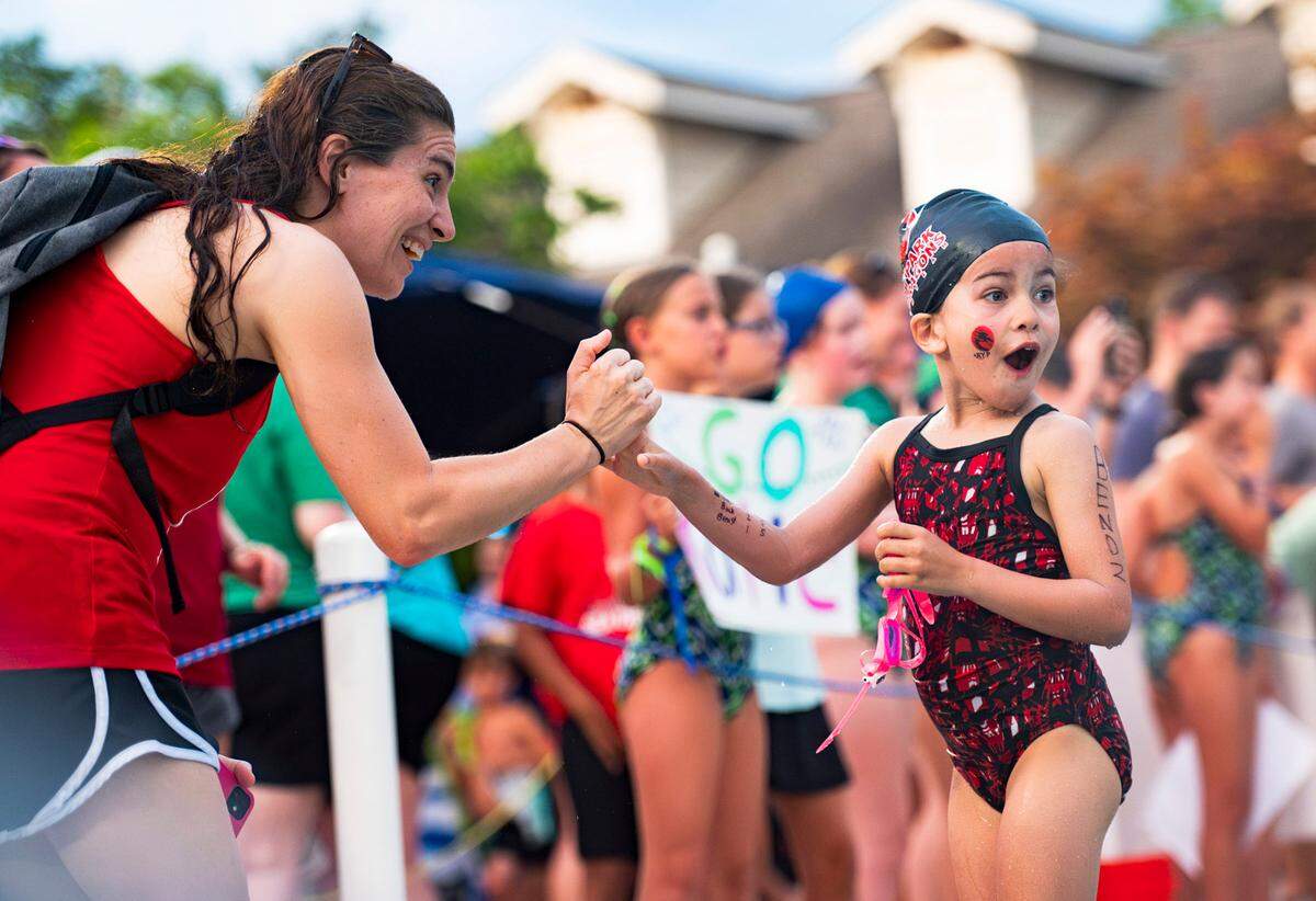 Lisa Bendz congratulates her daughter Victoria Bendz after her race at Cary Park Swim Club on June 25, 2024.