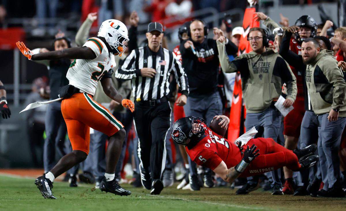 Miami safety James Williams (20) was flagged for throwing N.C. State quarterback Brennan Armstrong (5) to the ground during the second half of N.C. State’s 20-6 victory over Miami at Carter-Finley Stadium in Raleigh, N.C., Saturday, Nov. 4, 2023.