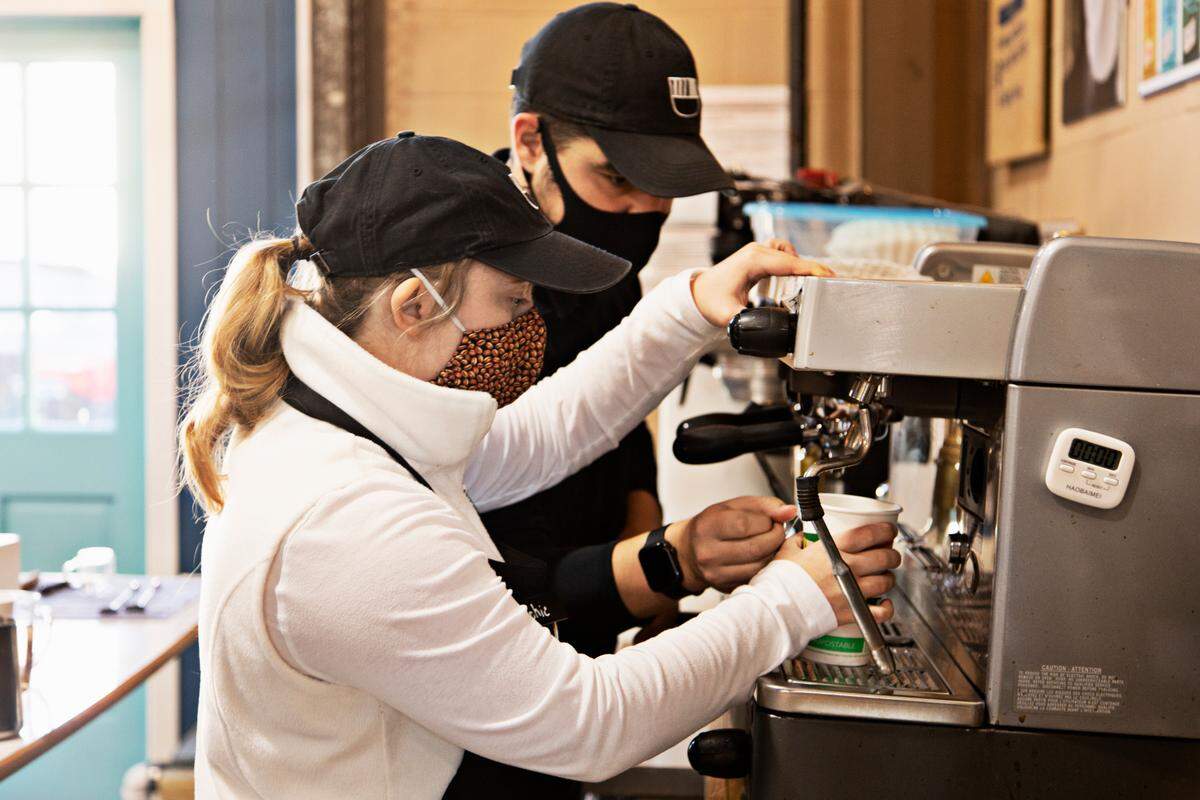 321 Coffee barista Sophie Pacyna, left, and co-founder Michael Evans take care of customer orders on Wednesday morning, Nov. 17, 2021.