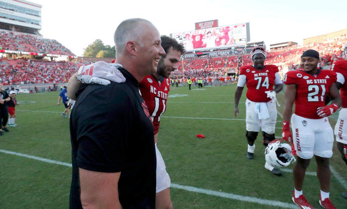 N.C. State head coach Dave Doeren walks off the field with linebacker Payton Wilson (11) after the Wolfpack’s 24-17 victory over Clemson at Carter-Finley Stadium in Raleigh, N.C., Saturday, Oct. 28, 2023.