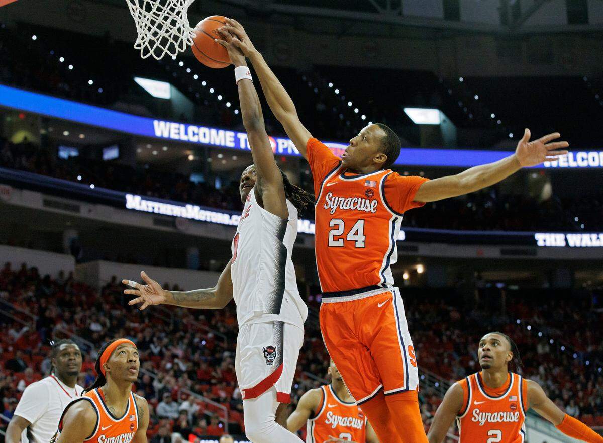 Syracuse’s Quadir Copeland blocks a shot by N.C. State’s DJ Horne during the Wolfpack’s 87-83 loss on Feb. 20, 2024, at PNC Arena.