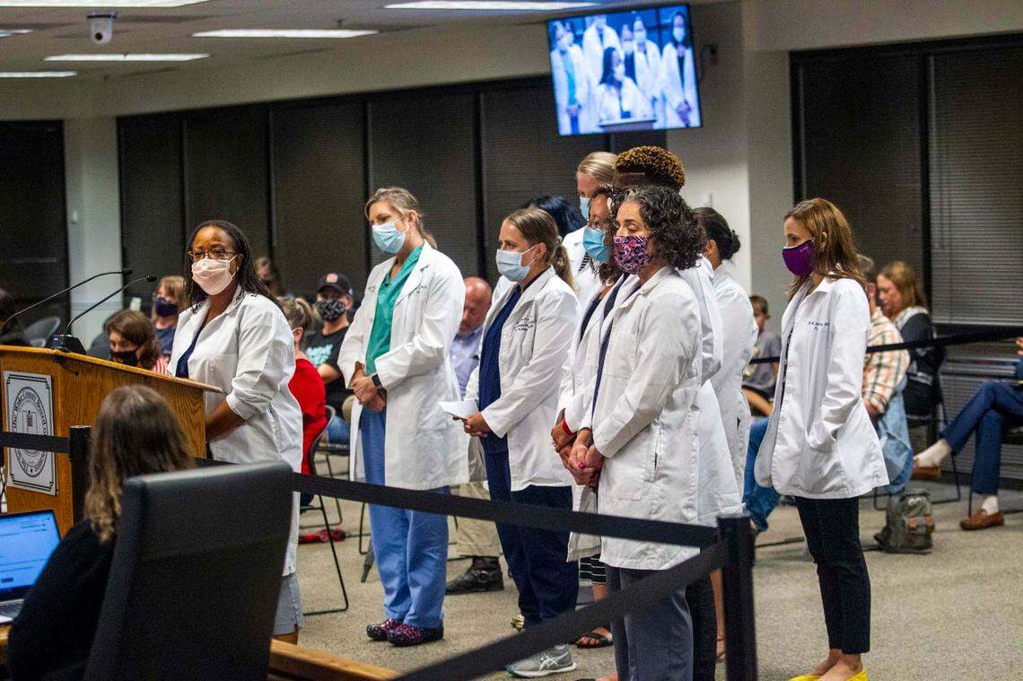 Dr. Michele Benoit-Wilson, far left, speaks in favor of a mask mandate during a Wake County Board of Education meeting in August 2021..