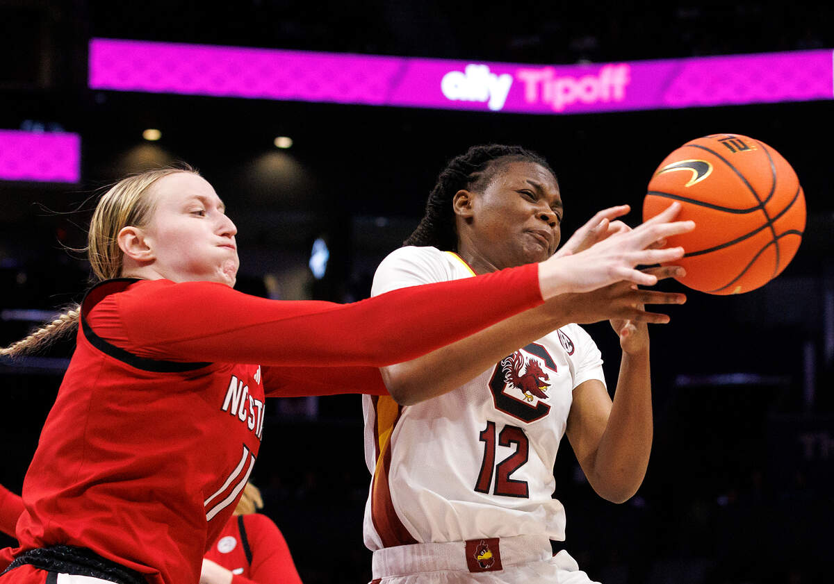 N.C. State’s Maddie Cox and South Carolina’s MiLaysia Fulwiley lunge for a loose ball during the first half of the Wolfpack’s 71-57 loss on Sunday, Nov. 10, 2024, at Spectrum Center in Charlotte, N.C.