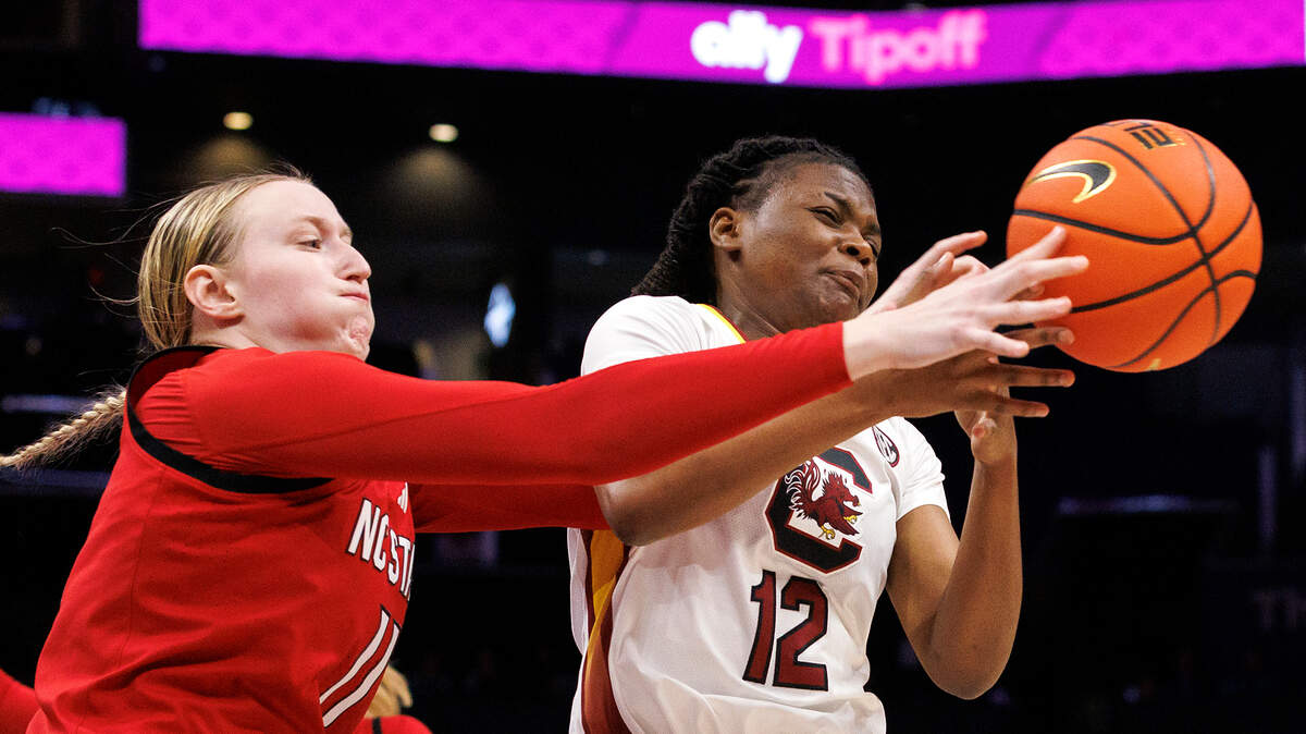 N.C. State’s Maddie Cox and South Carolina’s MiLaysia Fulwiley lunge for a loose ball during the first half of the Wolfpack’s 71-57 loss on Sunday, Nov. 10, 2024, at Spectrum Center in Charlotte, N.C.