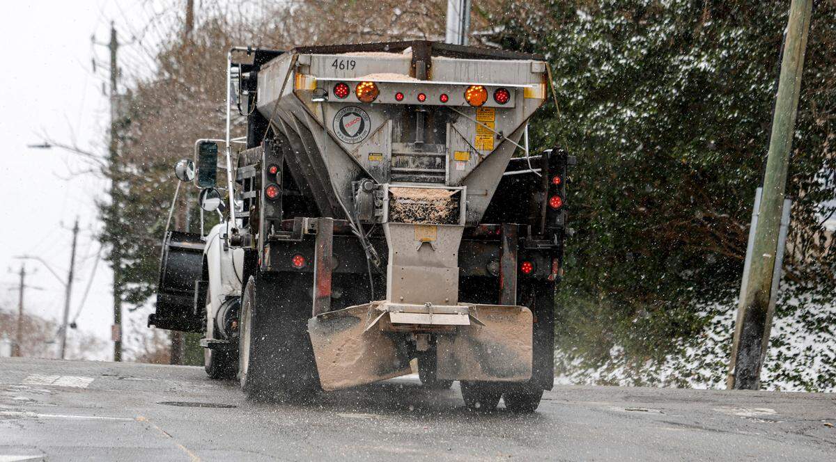 A truck spreads material on West Hargett St. near S. Boylan Ave. in Raleigh, N.C., Thursday, Feb. 20, 2025.