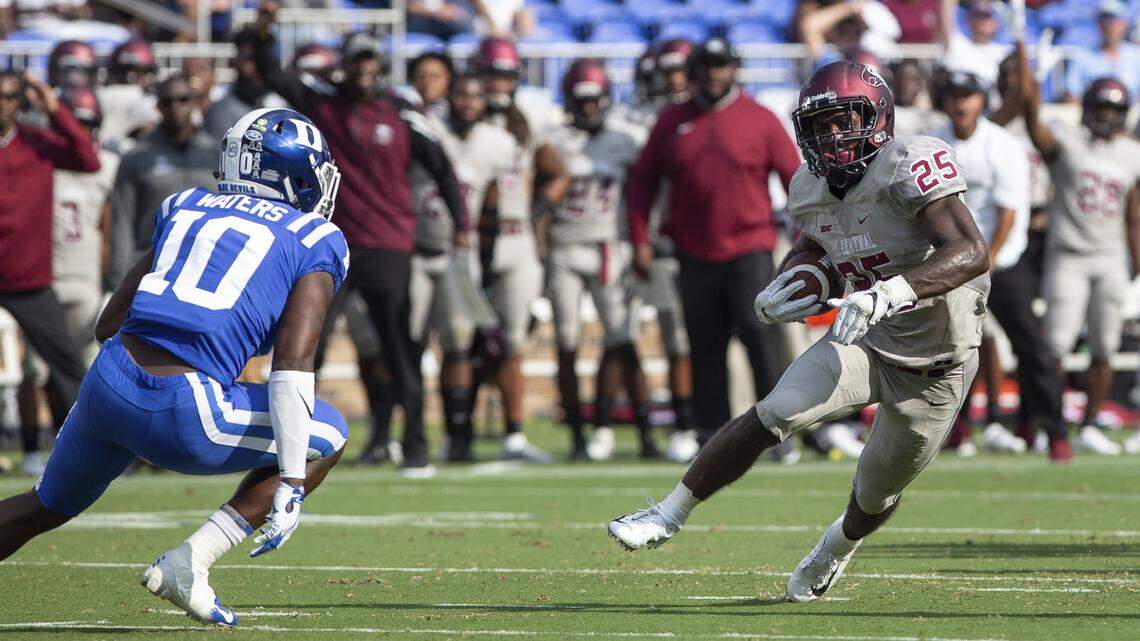 N.C. Central’s Isaiah Totten, right, carries the ball in front of Duke’s Marquis Waters during the Blue Devils’ 55-13 win over the Eagles on Saturday.