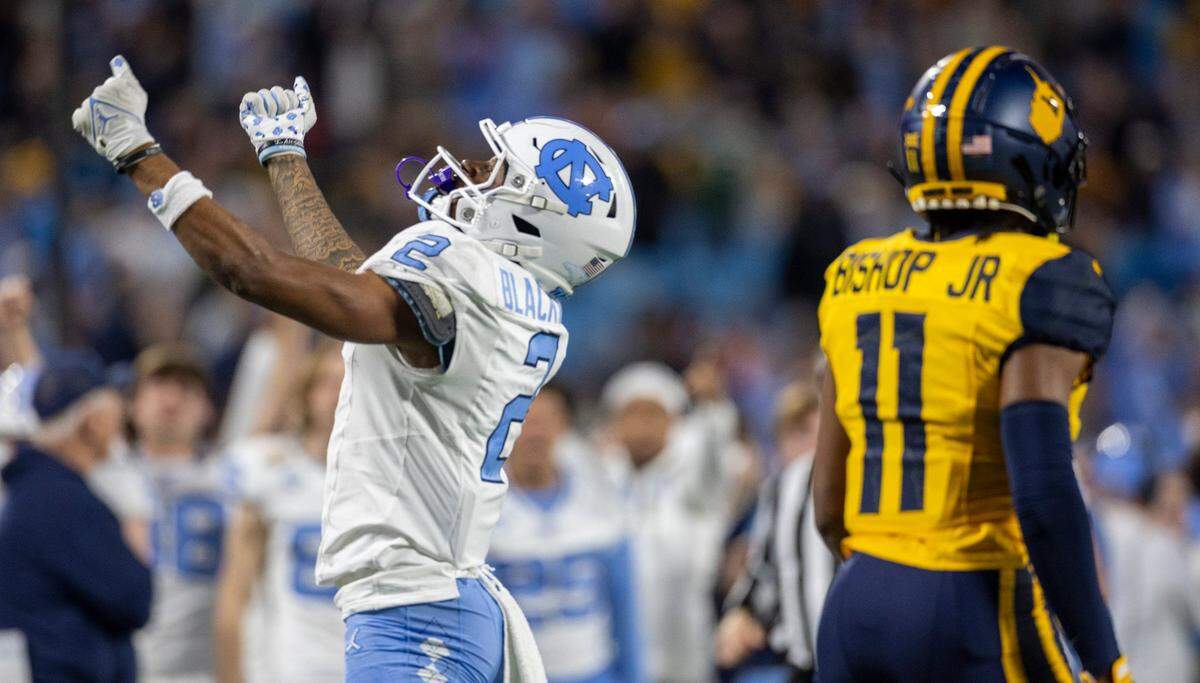 North Carolina’s Gavin Blackwell (2) reacts after picking up a first down on a 47-yards pass completion from quarterback Conner Harrell in the first quarter against West Virginia’s Beanie Bishop Jr. (11) during the Duke’s Mayo Bowl on Wednesday, December 27, 2023 at Bank of American Stadium in Charlotte, N.C.