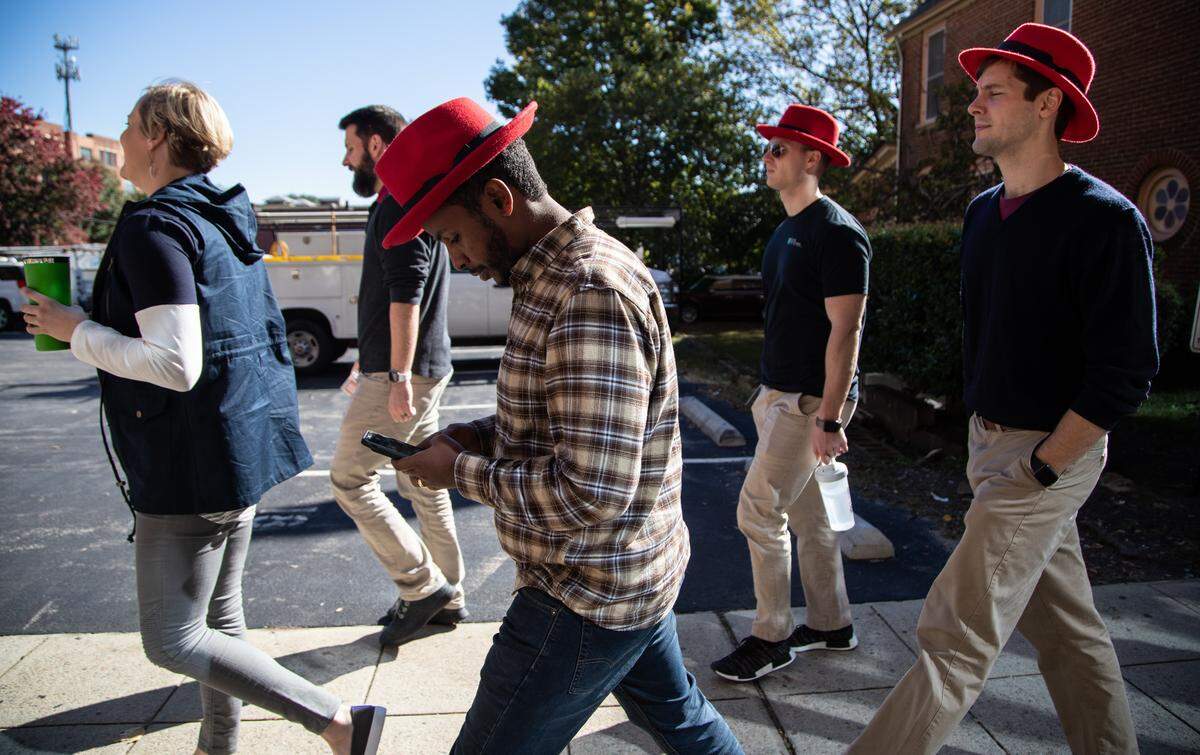Red Hat employees walk back to their Raleigh headquarters after a meeting at the Duke Energy Center for the Performing Arts on Oct. 29, 2018. The previous day, IBM announced it would buy the Raleigh software provider in a $34 billion deal.