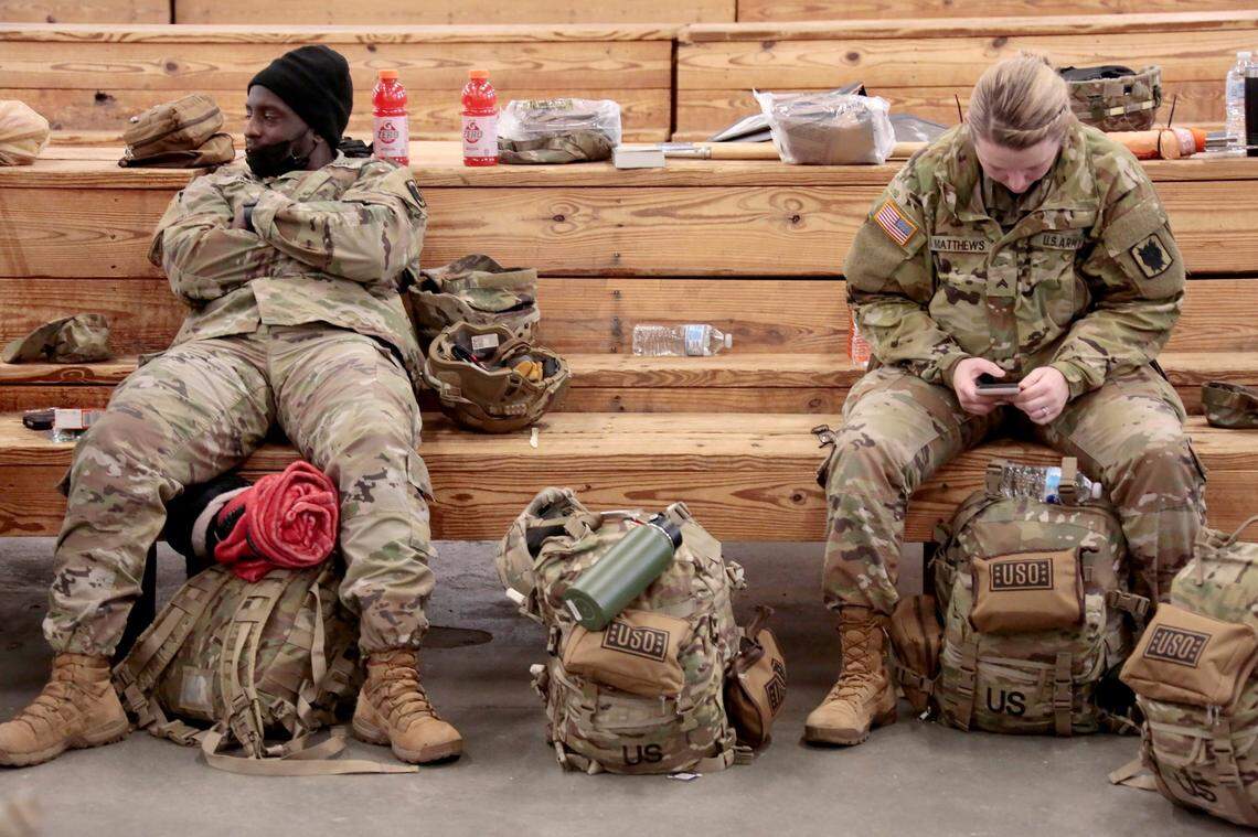 U.S. Army soldiers from the 18th Airborne Division sit in the staging area as they wait to board a C-17 aircraft to deploy to Europe on Thursday, Feb. 3, 2022 from Fort Bragg, N.C. President Joe Biden is ordering 2,000 U.S. troops to Poland and Germany amid the stalled talks with Russia over the Kremlin’s military buildup on Ukraine’s borders.