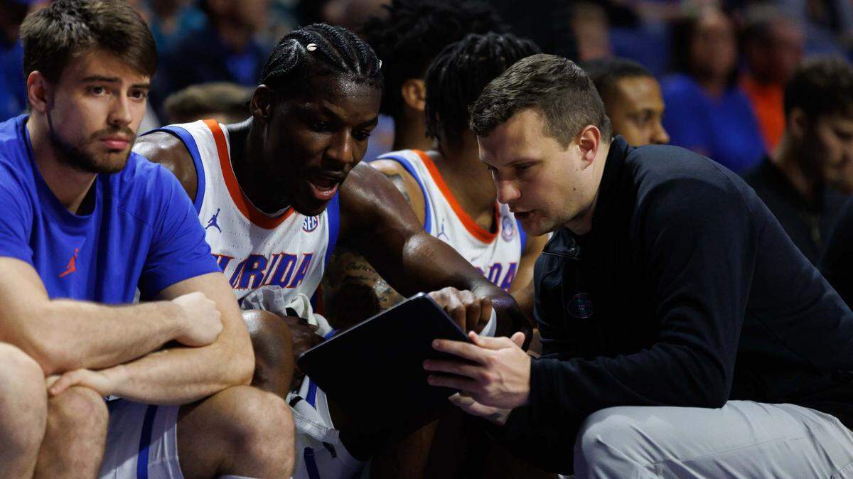 Florida Gators assistant coach John Andrzejek talks with Florida Gators center Rueben Chinyelu (9). Andrzejek was introduced as the new head coach at Campbell on Wednesday.