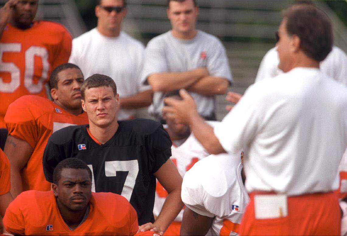 NCSU starting quarterback Philip Rivers listens to head coach Chuck Amato during a team meeting at the start of practice in August 2000.