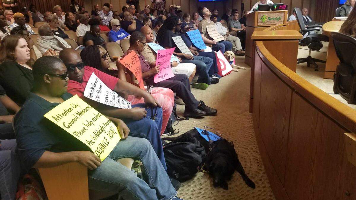 Several people, including many with visual impairments. criticized the city for problems with its paratransit system.
