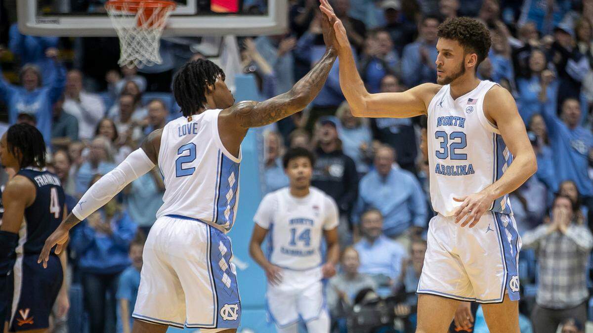 North Carolina’s Pete Nance (32) is congratulated by Caleb Love (2) after sinking a three point basket against Virginia during the first half on Saturday, February 25, 2023 at the Smith Center in Chapel Hill, N.C. Nance scored 14 points in the first half.