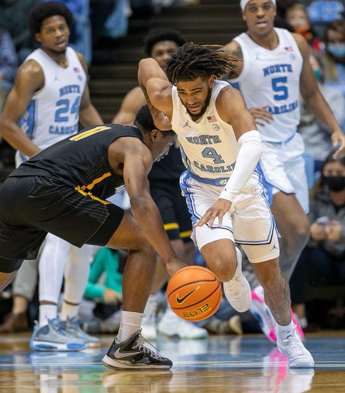North Carolina’s R.J. Davis (4) starts a fast break after making a steal from Appalachian State’s Donovan Gregory (11) during the second half on Tuesday, December 21, 2021 at the Smith Center in Chapel Hill, N.C.