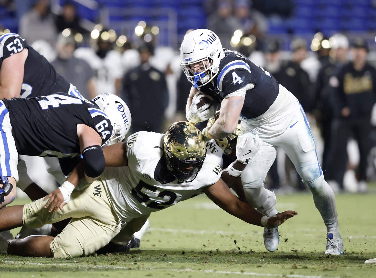 Duke’s Anderson Castle runs the ball past Wake Forest’s Dallas Afalava during the second half of the Blue Devils’ 49-32 win on Saturday, Nov. 29, 2025, at Wallace Wade Stadium in Durham, N.C.