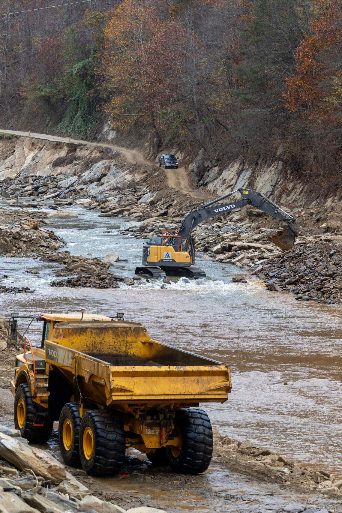 NCDOT contractors are reclaiming rock that washed downstream in the Cane River to use in rebuilding a 14-mile stretch of U.S. 19W in Yancey County.