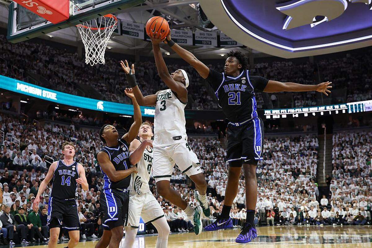 EAST LANSING, MICHIGAN - DECEMBER 06: Cam Ward #3 of the Michigan State Spartans has his first half shot blocked by Patrick Ngongba II #21 of the Duke Blue Devils at Breslin Center on December 06, 2025 in East Lansing, Michigan.  (Photo by Gregory Shamus/Getty Images)