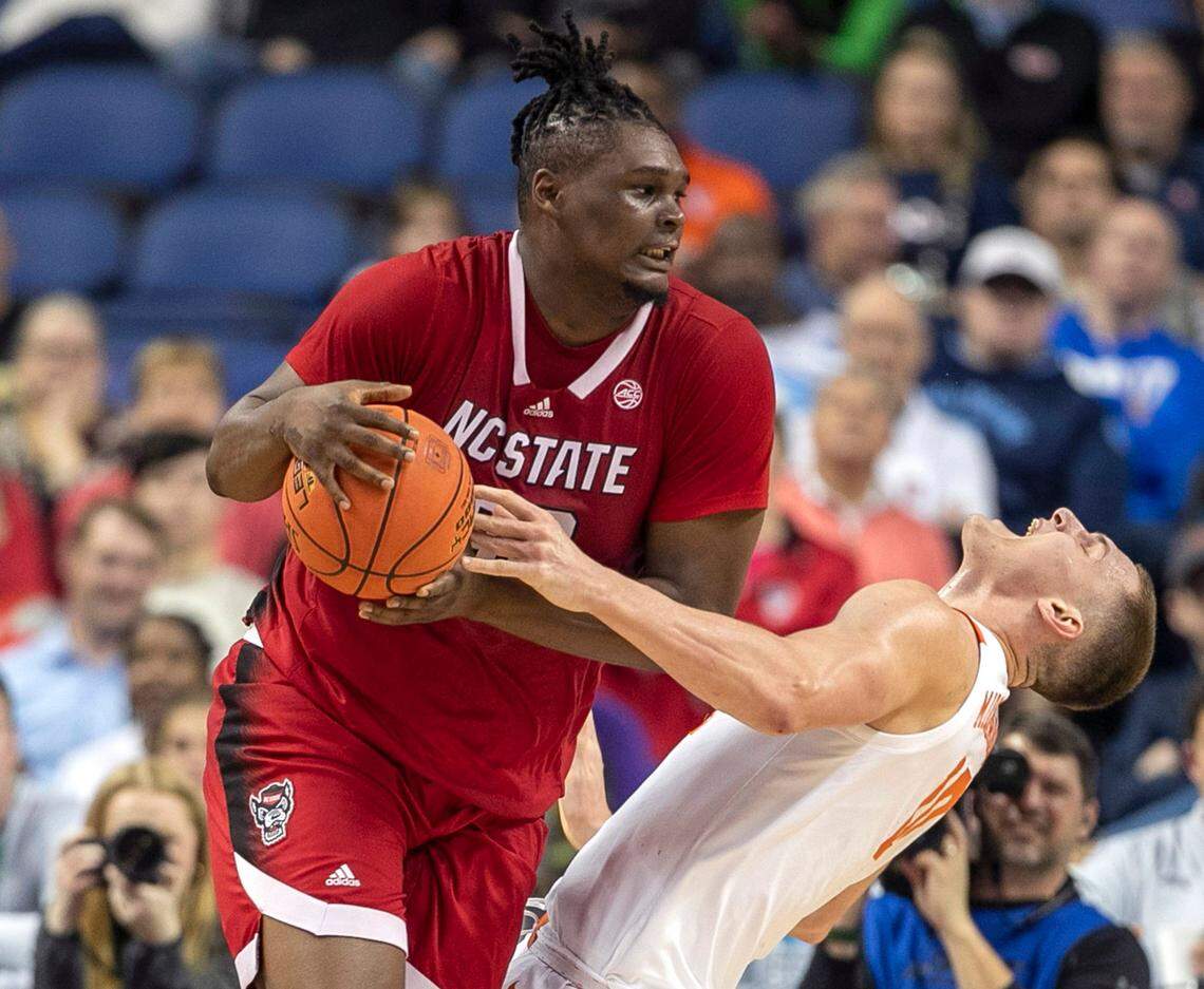 N.C. State’s D.J. Burns (30) collides with Clemson’s Ben Middlebrooks (10) during their game in the ACC Tournament on Thursday, March 9, 2023 at the Greensboro Coliseum in Greensboro, N.C.