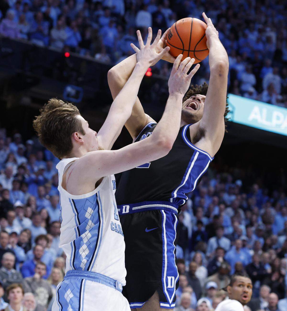 Duke’s Cameron Boozer (12) shot with 15 seconds left in the game does not fall as North Carolina's Henri Veesaar (13) defends during UNC’s 71-68 victory over Duke at the Dean E. Smith Center in Chapel Hill, N.C., Saturday, Feb. 7, 2026.