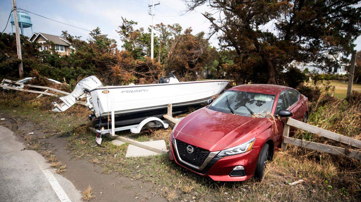 A car and a boat on Ocracoke, seen here on Friday, Sept. 13, 2019, are still sitting where they landed after being carried by flood waters during Hurricane Dorian. Itís estimated 300-400 vehicles were ruined during the storm.