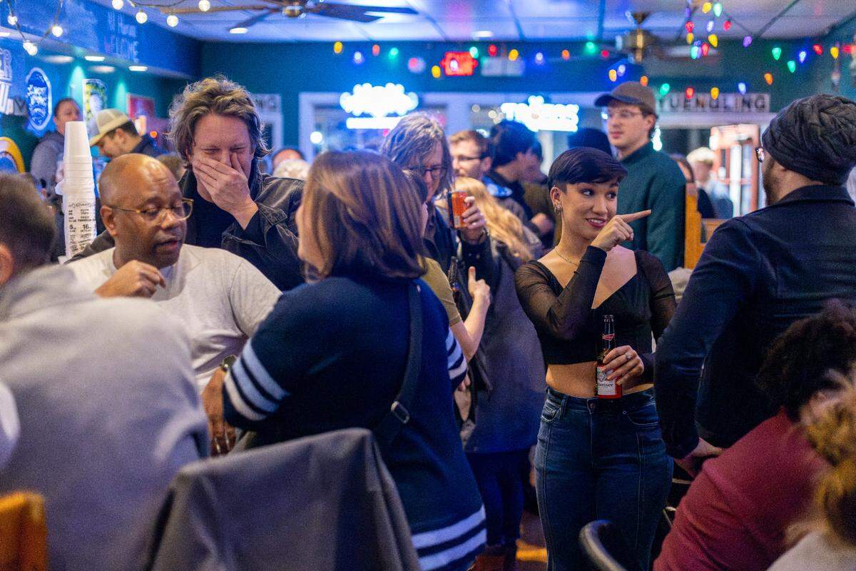 Taylor Brunson, right, talks with a group of former UNC students on Thursday, January 4, 2024 at Linda’s Bar & Grill in Chapel Hill, N.C. Brunson and her group were introduced to Linda’s by a poetry professor who often brought them to the popular spot on Franklin Street across from campus.