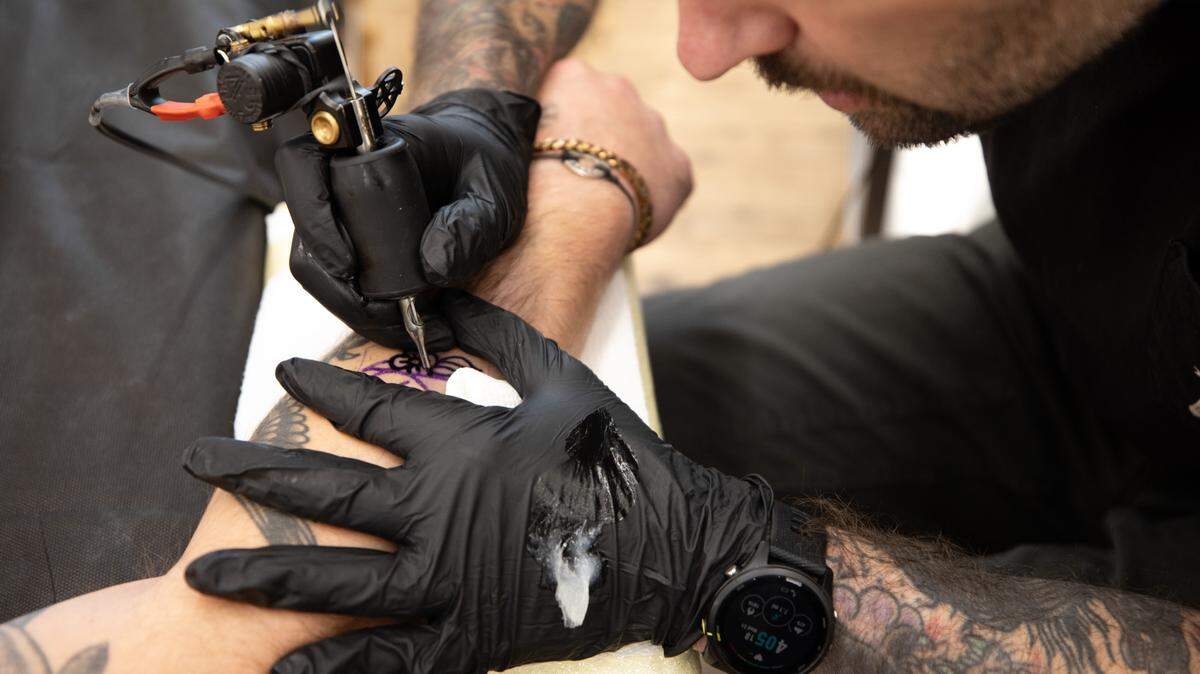 Tattoo artist Matt Evans gives a client some new ink at Welcome Tattoo in Durham, N.C. on Wednesday, June 21, 2023.