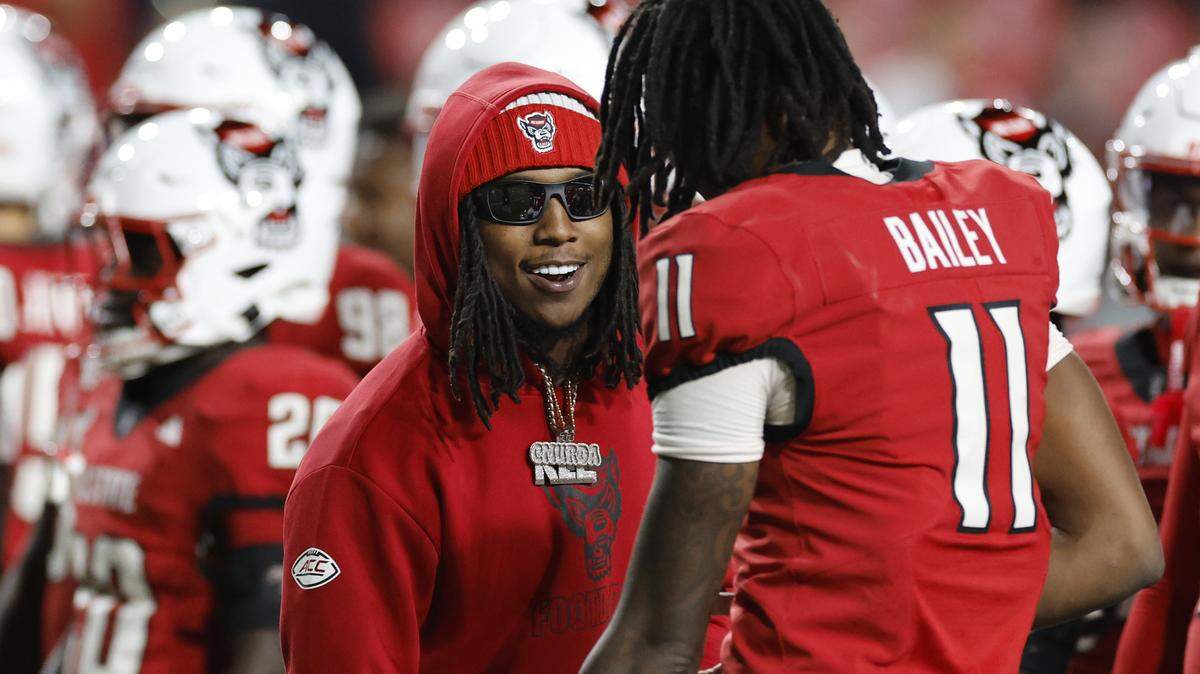 N.C. State running back Hollywood Smothers talks with quarterback CJ Bailey (11) during warmups before N.C. State’s game against Georgia Tech at Carter-Finley Stadium in Raleigh, N.C., Saturday, Nov. 1, 2025.