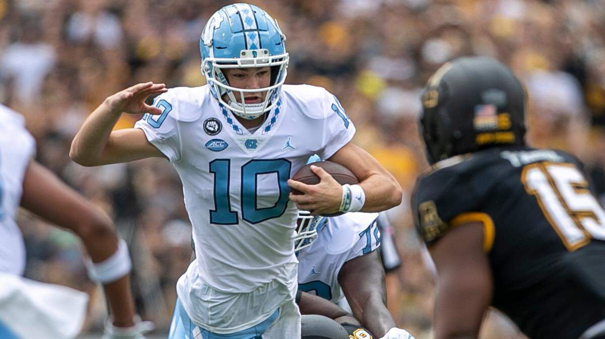 North Carolina quarterback Drake Maye (10) rushes for four yards before being stopped by Appalachian States Kevon Haigler (36) in the first quarter on Saturday, September 3, 2022 at Kidd Brewer Stadium in Boone, N.C.
